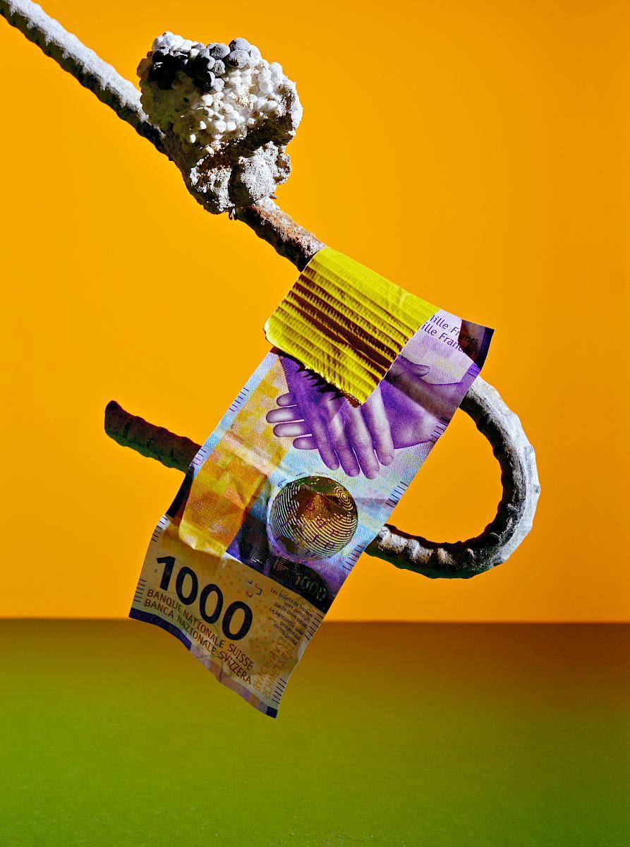 A 1000 franc note taped to a steel reinforcement bar